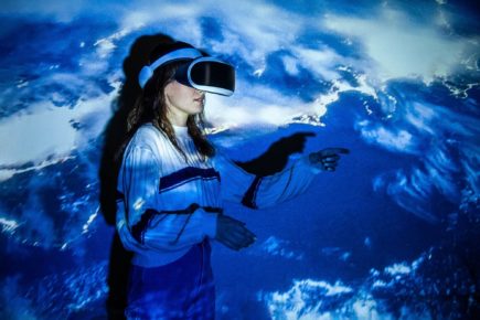 Woman,Using,Virtual,Reality,Headset,,Moving,Hand,At,Interactive,Technology